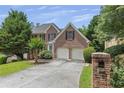 Charming brick two-story home with a two car garage and mature landscaping at 4815 Rapids Nw Cir, Acworth, GA 30102