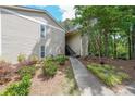 View of home's exterior with beautiful green landscape and manicured lawn at 2214 Lake Pointe Cir, Roswell, GA 30075