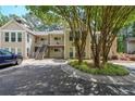 Condominium with multiple levels, exterior stairs, neutral color, landscaping, and mature trees in a well-maintained community at 2214 Lake Pointe Cir, Roswell, GA 30075