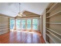 Bright living room with wood floors, built-in shelving, vaulted ceilings and lots of natural light at 2214 Lake Pointe Cir, Roswell, GA 30075