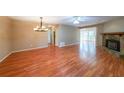 Spacious living room featuring a stone fireplace, wood floors, and great natural lighting at 2214 Lake Pointe Cir, Roswell, GA 30075