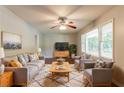 Cozy living room with hardwood floors, ceiling fan, lots of light, and comfortable seating arrangement at 4078 Bouldercrest Rd, Ellenwood, GA 30294