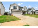 Charming home boasts a pristine lawn, two-car garage, and welcoming front porch at 4720 Dufour Dr, Lilburn, GA 30047