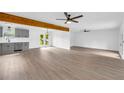 Spacious living room featuring grey vinyl floors, ceiling fans, and an open floor plan at 2657 John Petree Rd, Powder Springs, GA 30127