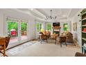 Cozy living room with fireplace, tray ceiling, and access to an outdoor deck at 3349 Concord Se Cir, Smyrna, GA 30080