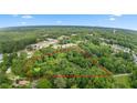 Aerial view of a large, private parcel outlined in red, surrounded by lush greenery and mature trees at 12728 Bells Ferry Rd, Canton, GA 30114