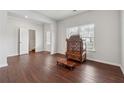 Bright living room with wood floors, a decorative cabinet, and easy access to the front entry at 520 Edgemore Rd, Canton, GA 30114