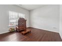 Inviting living room features dark wood floors, lots of natural light, and a rustic display cabinet at 520 Edgemore Rd, Canton, GA 30114