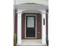 A covered entrance to the home showing brick accents, white columns and a black door with a window at 6895 Slate Stone Se Way # 3, Mableton, GA 30126