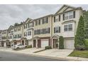 Row of townhomes with neutral siding, black shutters, manicured lawns, and attached garages in a well-maintained community at 6895 Slate Stone Se Way # 3, Mableton, GA 30126