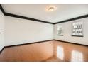 Bright living room with hardwood floors, white walls, dark trim, and large windows offering natural light at 6895 Slate Stone Se Way # 3, Mableton, GA 30126