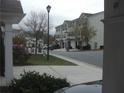 A residential street with townhomes with manicured lawns and a streetlight at 6895 Slate Stone Se Way # 3, Mableton, GA 30126