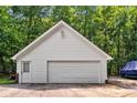 A two-car detached garage with a white door and white siding at 7212 Avalon Dr, Douglasville, GA 30135