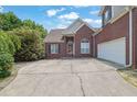 Brick home with an attached two car garage and concrete driveway at 4591 Millstone Walk Ne Dr, Buford, GA 30519