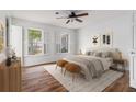 Cozy bedroom with hardwood floors, ceiling fan, and sunlit windows at 6 Stratford Hall Ne Pl, Atlanta, GA 30342