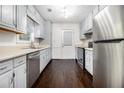 Well-lit kitchen featuring a stainless steel refrigerator, appliances and ample cabinet space at 1828 Brandy Woods Se Dr, Conyers, GA 30013