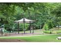 Community playground with a sun shelter, exercise equipment, and green spaces at 3175 West Manor Sw Cir, Atlanta, GA 30311