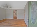 Inviting living room with hardwood floors and a view into the bright kitchen with a white refrigerator at 622 Sheffield Rd, Norcross, GA 30071