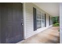 Home entry showcasing the front door and covered porch with black shutters at 10073 Dorothy Ct, Jonesboro, GA 30236