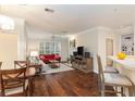 Bright living room featuring hardwood floors, a fireplace, plantation shutters and neutral paint at 2400 Cumberland Se Pkwy # 613, Atlanta, GA 30339