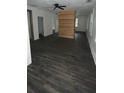Open living area with stylish wood-look floors and natural light from multiple windows at 4 Ivy St, Porterdale, GA 30014