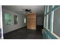 Bright living room featuring wood-look floors, large windows, and a modern ceiling fan at 4 Ivy St, Porterdale, GA 30014