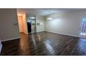 Living room featuring hardwood floors, access to the kitchen, a dining area, neutral paint, and natural light at 5517 Green Wing Ct, Lithonia, GA 30058