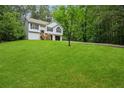 Traditional split-level home with black shutters, lush lawn and mature trees at 835 Navajo Trl, Covington, GA 30016