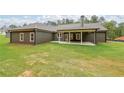 Spacious backyard featuring a covered patio, perfect for outdoor entertaining and relaxation at 96 Lexie Ct, Rockmart, GA 30153