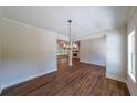 Dining area with wood-look floors and chandelier, and a view into the adjacent living room at 96 Lexie Ct, Rockmart, GA 30153