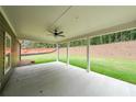 Enjoy outdoor living on this covered patio with ceiling fan and ample space to entertain at 96 Lexie Ct, Rockmart, GA 30153