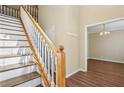 Welcoming foyer with hardwood floors and staircase, adjacent to a dining area at 1039 Megan Ct, Sugar Hill, GA 30518