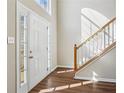 Bright foyer with hardwood floors and a staircase leading to the second floor at 1039 Megan Ct, Sugar Hill, GA 30518