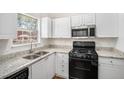 Well-lit kitchen with white cabinets, granite countertops, stainless steel appliances, and a view from the window at 277 Ralph David Abernathy Sw Blvd, Atlanta, GA 30312
