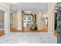Grand foyer featuring marble floors and a curved staircase at 4670 Hamden Forest Sw Dr, Atlanta, GA 30331