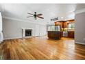 Open concept living space with hardwood floors, fireplace, and adjacent kitchen at 5610 N Allen Rd, Mableton, GA 30126