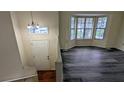 Bright living room with hardwood floors, large windows, and natural light from the entrance foyer at 2168 Sara Ashley Way, Lithonia, GA 30058