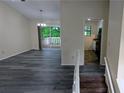Open-concept living space featuring modern flooring, a sliding glass door to the deck, and access to the kitchen at 2168 Sara Ashley Way, Lithonia, GA 30058