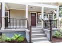 Inviting front porch with craftsman style railings, posts, and stylish front door at 8316 Grady St, Douglasville, GA 30134