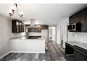 Open-concept kitchen with stainless steel appliances, granite countertops, and modern finishes at 8316 Grady St, Douglasville, GA 30134