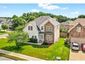 Beautiful two-story home with a manicured lawn, stone facade, and attached garage at 910 Pebble Creek Trl, Suwanee, GA 30024