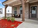 Inviting front porch with brickwork, comfortable seating, and stylish decor at 2456 Hidden Creek Rd, Kennesaw, GA 30152