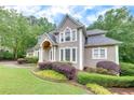 Elegant home with lush landscaping, showcasing its architectural details and curb appeal at 3028 Towneside Ln, Woodstock, GA 30189