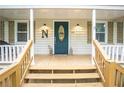 Inviting front porch with a well-decorated entry way and a cozy welcome at 4409 Woodward Mill Rd, Sugar Hill, GA 30518