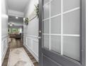 Stylish entryway with decorative molding and modern door, leading to an open living area at 197 Cherokee Reserve Cir, Canton, GA 30115