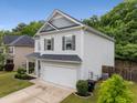 Charming two-story home with gray siding, well-manicured lawn, and attached two car garage at 197 Cherokee Reserve Cir, Canton, GA 30115