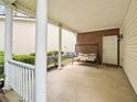 Covered back porch featuring a porch swing for relaxation, complemented by brick accents at 2545 Gatewater Ct, Cumming, GA 30040