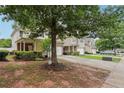 Landscaped front yard with mature trees enhances the curb appeal of these inviting townhomes at 2545 Gatewater Ct, Cumming, GA 30040