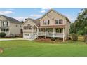 Charming two-story home with a welcoming front porch, attached two-car garage, and landscaped yard at 113 Westchester Xing, Canton, GA 30115
