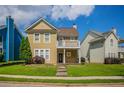 A quaint two-story home with a charming balcony and manicured lawn at 4634 Garden Hills Dr, Stone Mountain, GA 30083